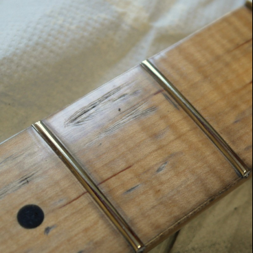 Adjust maple fingerboard wear