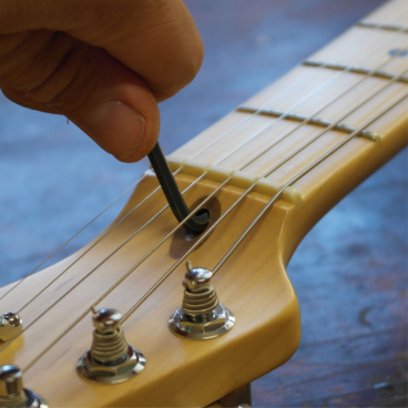Truss-rod adjustment to the headstock